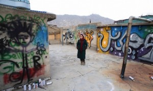 Afghan artist Shamsia Hassani poses for a photograph on the roof of her graffiti workshop in Kabul